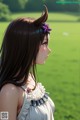 A girl with long brown hair and a flower in her hair.