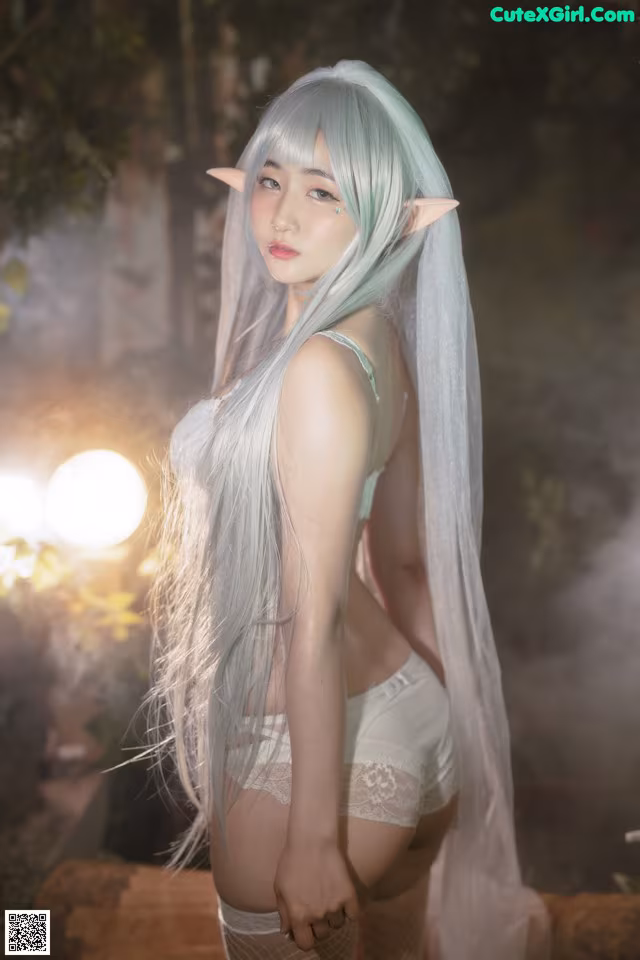 A woman with long white hair wearing a white dress.